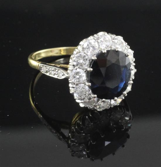 An 18ct gold, sapphire and diamond oval cluster ring, size O.